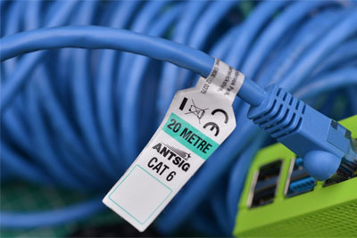 Cat 6 Ethernet cable plugged into optical network terminal for fiber internet connection.