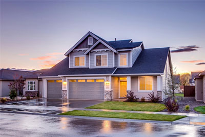 A two-story home in a residential neighborhood. Homes like this make up the “last mile” of fiber internet connectivity. So, with fiber to the home, this residence could get the fastest internet speeds available.