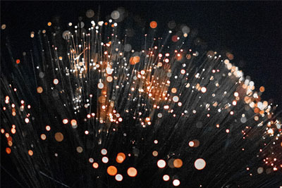 The end of a fiber cable showing light