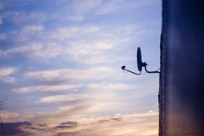 House with a satellite dish installed for satellite internet connection.