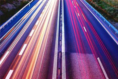 A symmetrical highway with light trails, symbolizing equal and high-speed internet connectivity