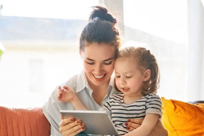 A mother and daughter playing on a tablet