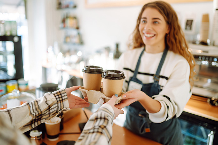 Woman serving coffee inside her small business in Lancaster Ohio