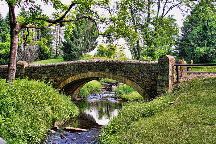A stream flowing under an old stone bridge in Warrenton, Virginia